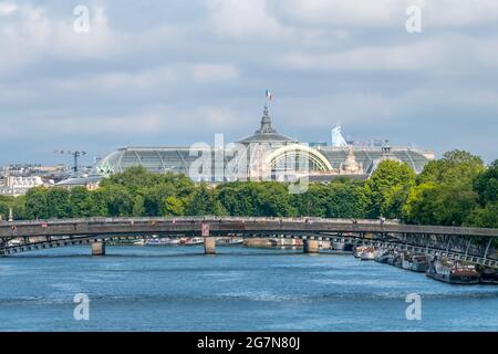 France. Summer day in Paris. The roof of the Grand Palace and residential barges are moored at the embankment of the Seine River Stock Photo