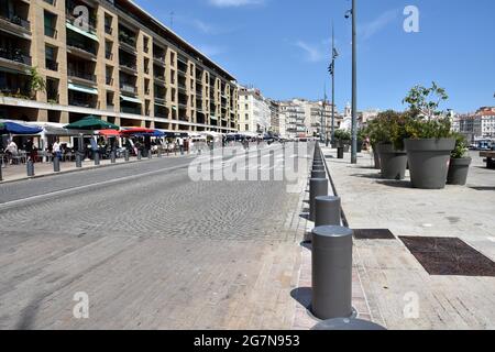 Marseille, France. 10th July, 2021. Quai du Port seen vegetated and pedestrianized in Marseille.For the second consecutive year, the city of Marseille is offering a 'Marseille summer' from July 1 to August 31, 2021. For the occasion, Quai du Port is made a pedestrian area between the Ombrière and Fort Saint-Jean decorated with dozens of columns of flower-filled and vegetated spaces. Credit: SOPA Images Limited/Alamy Live News Stock Photo