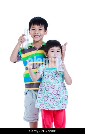 Asian children with thumb up. Drinking milk for good health. Boy and girl drinking milk, isolated on white background. Studio shoot. Concept about the Stock Photo