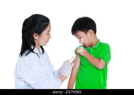 Doctor vaccinating boy's arm. Asian illness boy worry about vaccine syringe. Isolated on white background.  Human health care and medical concept. Stock Photo