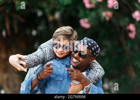 Happy Moments. Cheerful Black Couple Taking Selfie On Smartphone While Having Romantic Date travel, middle age African American Spouses in trip. Mixed race couple . Stock Photo