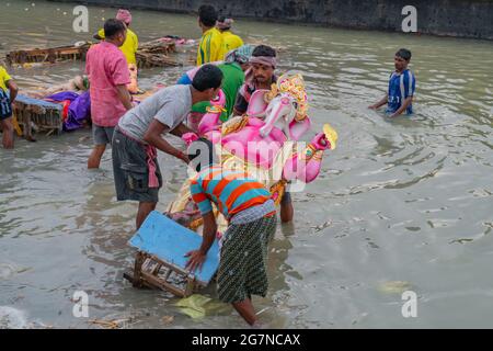 KOLKATA, WEST BENGAL, INDIA - 30 SEPTEMBER 2017: Idol of Lord Ganesha is being immersed in Holy river Ganges. Celebrated by Hindus as 'vijaya dashami' Stock Photo