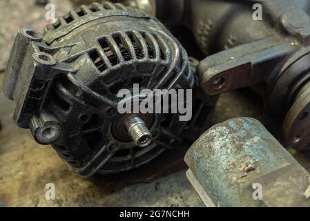 Old car alternator detail in a workshop bench Stock Photo