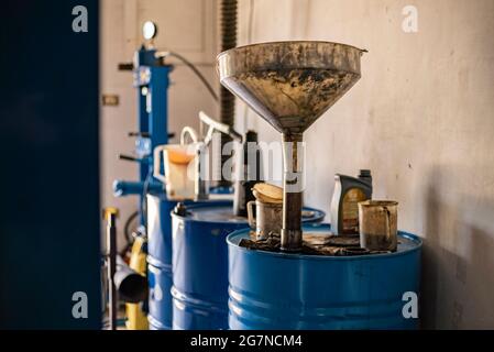 Used engine oil collection in a workshop, used oil barrel Stock Photo