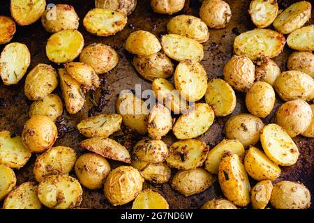 Roasted Herb Mustard Potatoes on a Sheet Pan: Roasted baby Yukon gold potatoes on a metal baking sheet Stock Photo