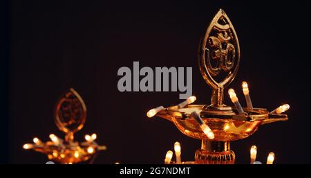 Traditional gold ornamented candleholder decorated with festive light Stock Photo