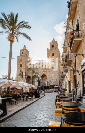 Cefalu,Sicily - June 6,2021.Roman Catholic cathedral,Duomo, at sunrise.Famous UNESCO Heritage site in Italy.Facade of church with two large Norman Stock Photo
