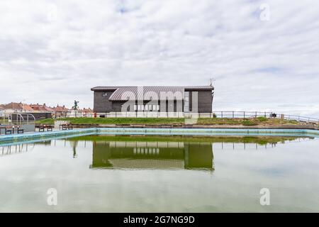 Hoylake Lifeboat Station, reflected in the boating lake, Hoylake, Wirral, UK. Established 1803, it is one of the oldest lifeboat stations in the UK. Stock Photo