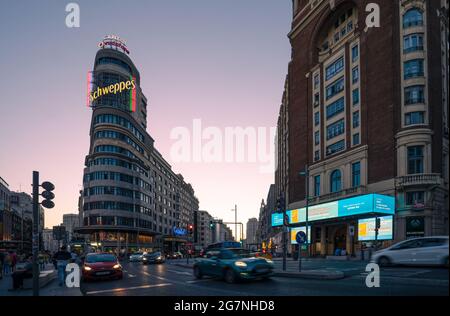 Madrid, Spain - June 2019: Gran via Avenue at the iconic schweppes building. Stock Photo