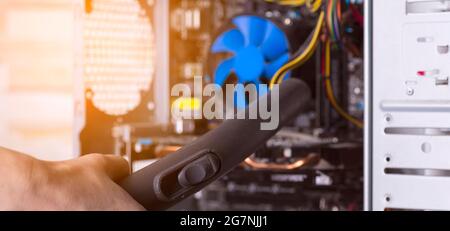 Cleaning the system unit of a desktop computer from dust with a vacuum cleaner Stock Photo