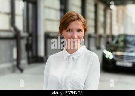 Caucasian businesswoman portrait smiling happily and looking at the camera. Stock Photo