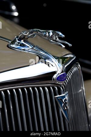 A decorative chrome greyhound hood ornament on the front of a 1934 Ford Phaeton V8 on display at a classic car show in Santa Fe, New Mexico. Stock Photo