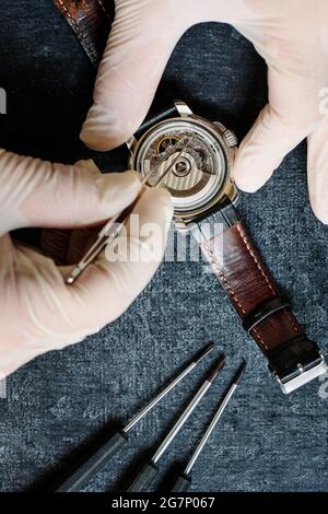 Watchmaker repairing an old wristwatch, top view Stock Photo