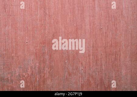 Detail of old gate texture painted in salmon pastel tones with weathered metal surface and cracked paint. Clean abstract background with empty space Stock Photo