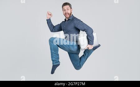 entrepreneur running and hurrying. agile business. network administrator hold computer. Stock Photo