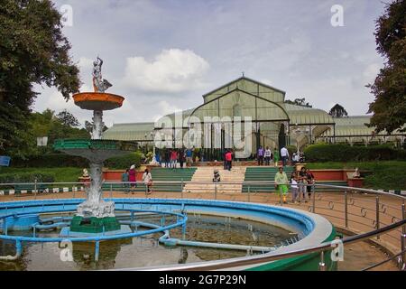 Bangalore, India - September 11, 2016: Wide angle view of fountain against famous glass house at lal bagh in Botanical Garden in a state of Karnataka. Stock Photo