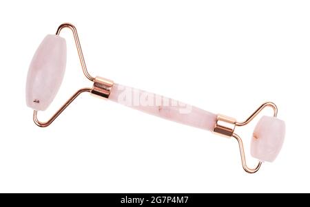 roller massager for traditional chinese face massage gua sha made from natural rose quartz stone isolated on white background Stock Photo