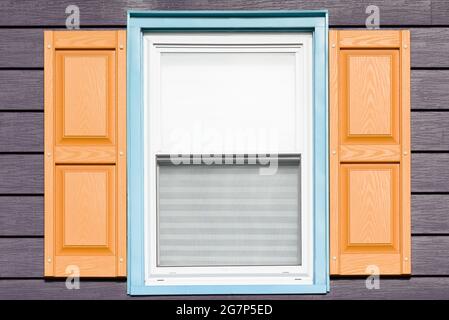 Creative, contemporary window colors shown on a close up of one window on a home. Stock Photo