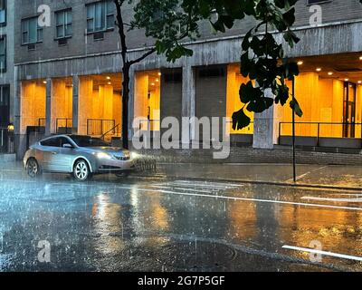 Traffic in Midtown Manhattan During a Violet Summer Rainstorm, NYC, USA Stock Photo