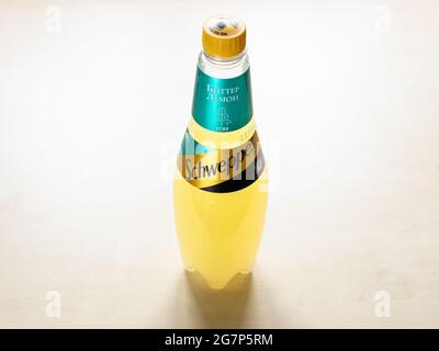 MOSCOW, RUSSIA - JUNE 10, 2021: russian edition plastic bottle of Schweppes Bitter Lemon water on light brown board. Schweppes introduced its brand of Stock Photo
