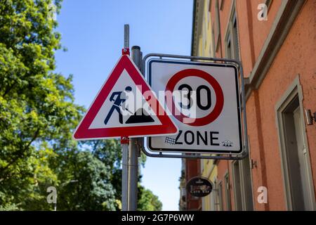 Selective focus of road signs on a metal post against a blurred background Stock Photo