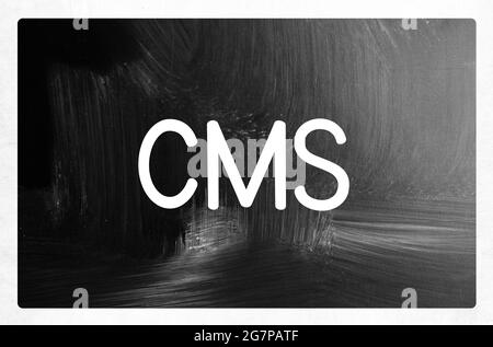 Grayscale illustration with the acronym of the "Content management system" on the blackboard Stock Photo