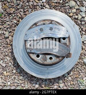 A Worn Out Brake Rotor and Pads Stock Photo