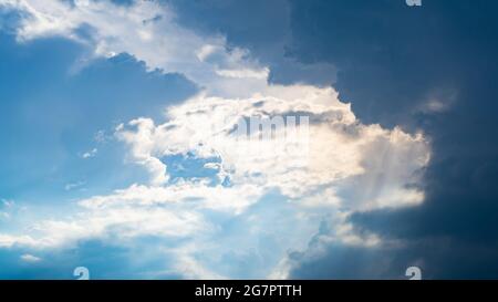 Blue sky with cloud and sunrays Stock Photo