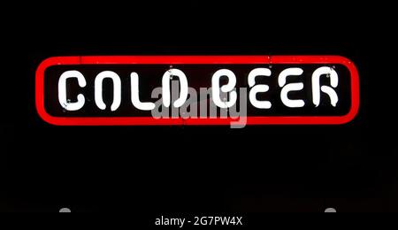 Bright neon white illuminated cold beer sign on a black background Stock Photo