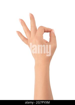 Womans hand ok sign on white background. Gesture all right everything is OK. Isolated white. Close-Up Of Hand Gesturing Against White Background Stock Photo