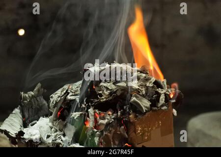 Selective focus shot of burning fire and its ashes Stock Photo