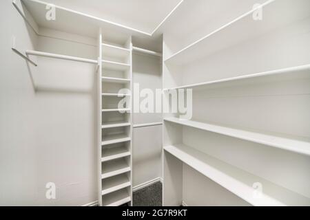 White windowless walk-in closet with tall cabinet in the middle Stock Photo  - Alamy