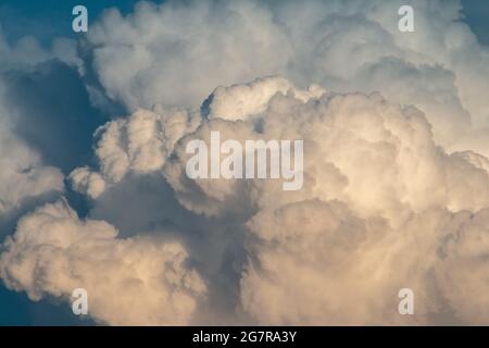 fluffy stormy clouds in the sunset sky Stock Photo