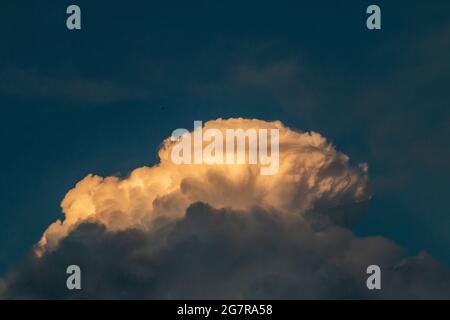 fluffy stormy clouds in the sunset sky Stock Photo