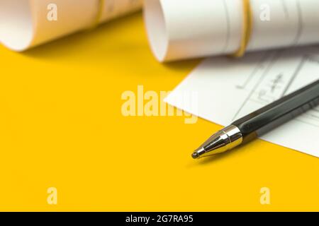 Working on drawing sketch plans and blueprints. Desktop with pencil. Copy space photo Stock Photo