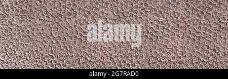 Abstract brown plaster with pattern of small circles in the sunlight Stock Photo