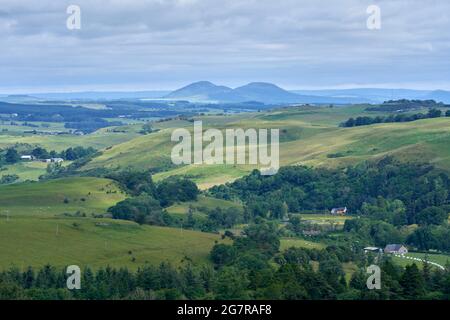 View of The Eildon Hills across mixed use farmland from south of Hawick in the Scottish Borders. Stock Photo