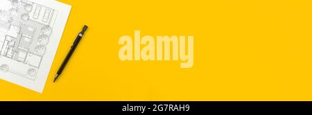 Banner construction and architect design concept. Residential building drawings and architectural blueprint on business desktop with pen. Yellow backg Stock Photo