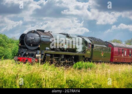 SR Merchant Navy Class 35018 British India Line steam locomotive  seen on the West Coast Main Line heading south on a positionin Stock Photo