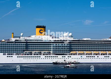 Santorini island - Greece - October 3 2018 : Holiday cruise ship at anchor. Close up view of of boat. Blue sky and copy space. Stock Photo