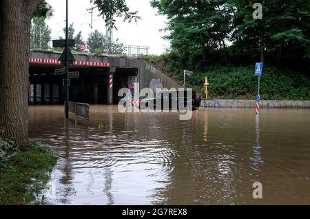 Düsseldorf, Germany - 15 July 2021: Extreme weather - a jeep tries to navigate on a flooded street in Düsseldorf, Germany Stock Photo