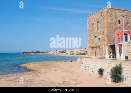 Daytime at Punta Secca Beach with the Torre Scalambri in Santa Croce Camerina, Sicily, Italy Stock Photo