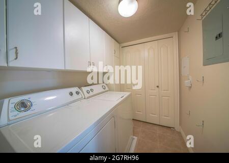Laundry room interior with wall cabinets and closet Stock Photo