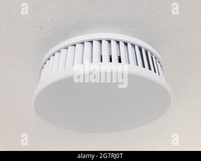 smoke detector on ceiling, fire alarm device - Stock Photo