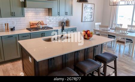 Pano Kitchen and dining room of home with island cabinets and wooden floor Stock Photo