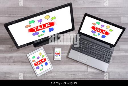 Talk concept shown on different information technology devices Stock Photo