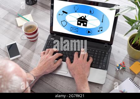 Smart home automation concept shown on a laptop used by a man Stock Photo