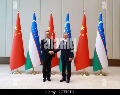 Tashkent, Uzbekistan. 15th July, 2021. Visiting Chinese State Councilor and Foreign Minister Wang Yi (L) meets with Uzbek President Shavkat Mirziyoyev in Tashkent, Uzbekistan, July 15, 2021. Credit: Cai Guodong/Xinhua/Alamy Live News Stock Photo