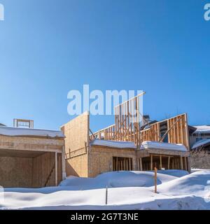 Square frame Home under construction on a snowy residential neighborhood in Park City Utah Stock Photo