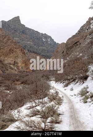 Vertical Provo Canyon snowy hiking trail in between the mountain slope at Utah Stock Photo